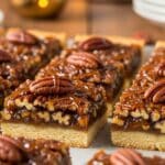 Salted Maple Pecan Pie Bars topped with whipped cream and flaky sea salt, perfect Maple Pecan Desserts