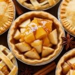 Muffin pan with Mini Apple Pies before baking, showing pie crust circles