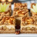 Golden Caramel Apple Cheesecake Bars with streusel topping on a baking tray