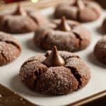 Chocolate Peanut Butter Blossom Cookies topped with Hershey’s Kisses on a holiday plate